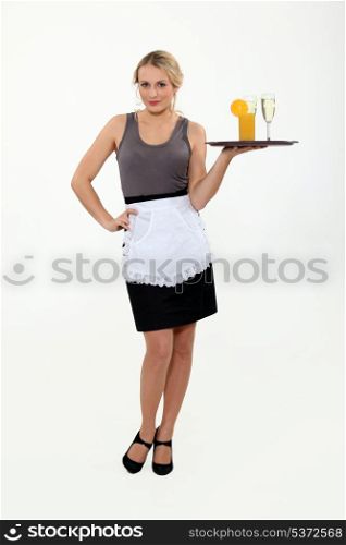 Waitress bringing drinks on a tray.