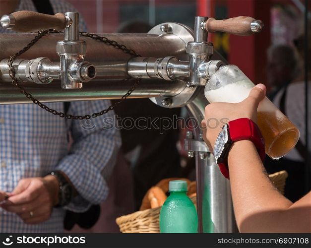Waitress Hand Pouring a Pint of Beer from the Tap
