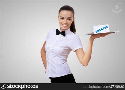 Waitress holding a tray with word success on it