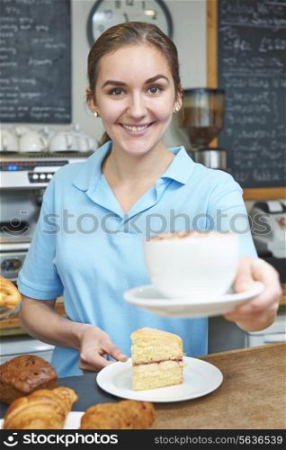Waitress In Cafe Serving Customer With Coffee
