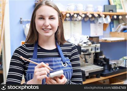 Waitress In Cafe Taking Customer Order
