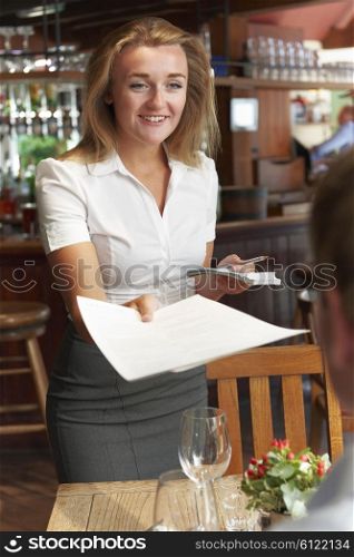 Waitress In Restaurant Handing Customer Menu