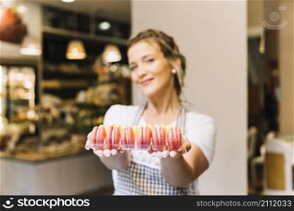 waitress offering macarons