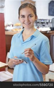 Waitress Ready To Take Order In Cafe