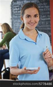 Waitress Ready To Take Order In Cafe