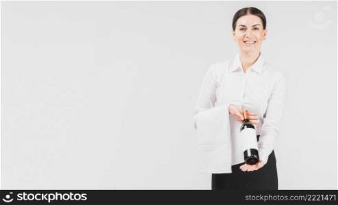 waitress smiling holing bottle wine