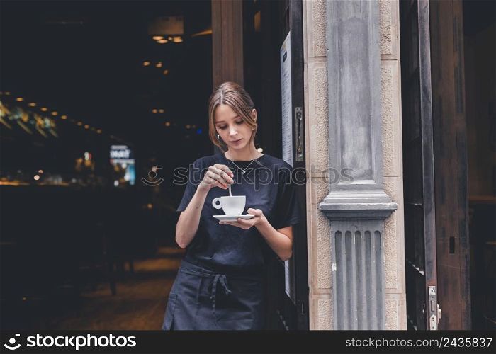 waitress stirring hot beverage