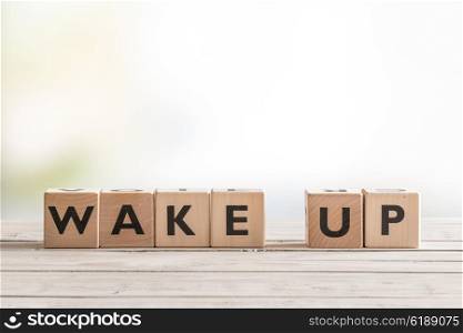 Wake up sign with wooden cubes on a table