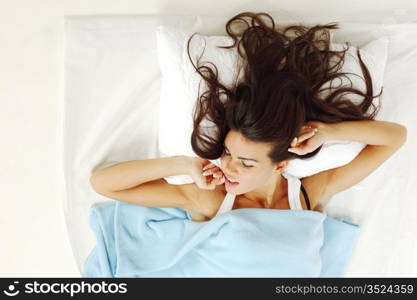 waking woman on the white pillow