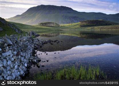 Wales, Gwynedd, Snowdonia. Countryside landscape and mountains in beautiful morning light reflected in calm Cregennen Lakes in Snowdonia National Park.. Countryside landscape and mountains in beautiful morning light reflected in calm Cregennen Lakes in Snowdonia National Park