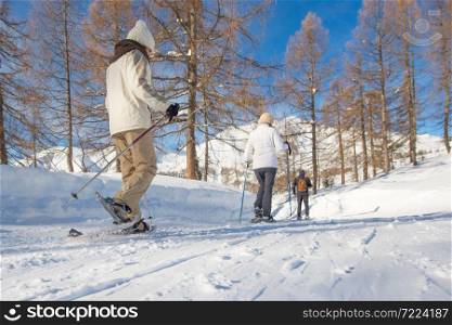 Walk in the snow with snowshoes on a beaten track