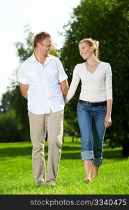 Walk of a cheerful couple in a summer garden