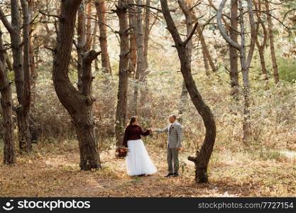 walk of the bride and groom through the autumn forest in October