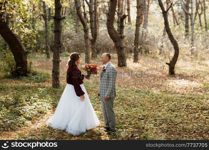 walk of the bride and groom through the autumn forest in October