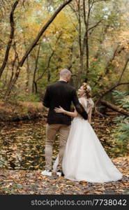 walk of the bride and groom through the autumn forest in October