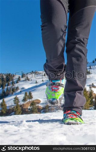 Walk on the snow with boots and crampons