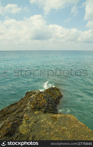 Walk over sea breaking on the rocks