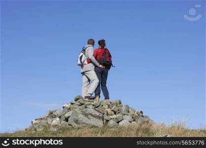 Walkers Standing On Pile Of Rocks