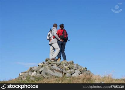 Walkers Standing On Pile Of Rocks