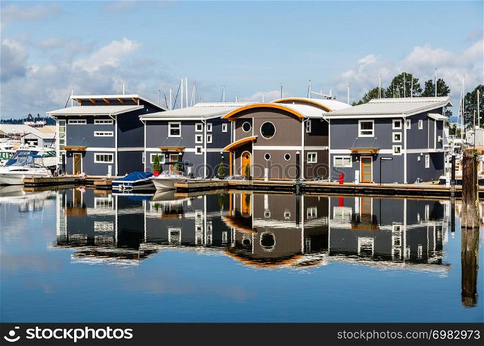 Walking along the waterfront on the North Shore of Vancouver, I came across these marina homes reflected in the absolutely still blue water