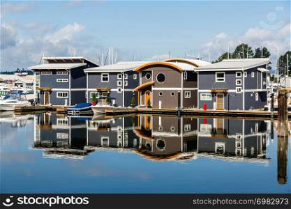 Walking along the waterfront on the North Shore of Vancouver, I came across these marina homes reflected in the absolutely still blue water