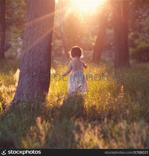 Walking baby in sunset lights