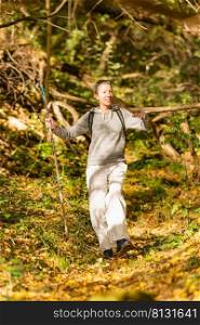 Walking mindfulness. Mindful middle-aged woman walking through the autumn forest. . Walking mindfulness