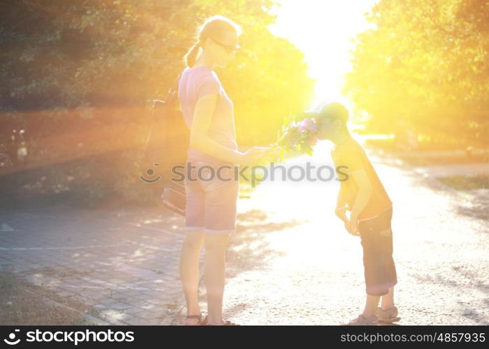 walking on sunrise. Blurred photo of walking woman with her son on sunrise