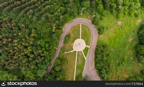 walking trail in the park. shooting from a drone from a height of 150 meters. view of the road and the forest. Abrupt turn. road through the green forest. View from above