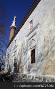 Wall and minaret Yeshil Jami mosque in Bursa, Turkey