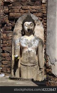 Wall and standing Buddha in wat Phra Si Ratana Mahaphat, Si Satchanalai, Thailand