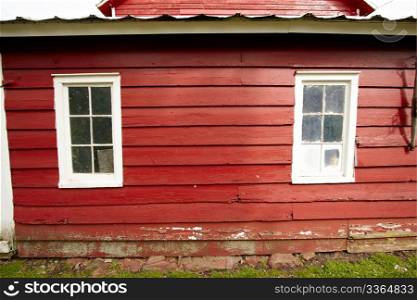 Wall and windows of the old red barn.
