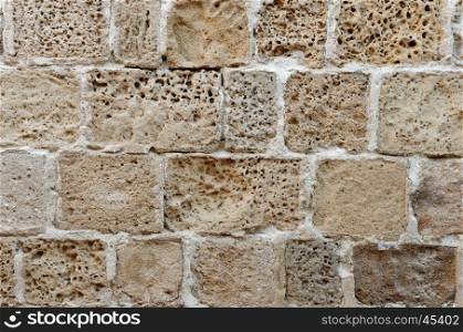 Wall built of rough weathered sandstone blocks