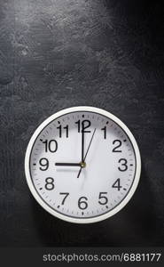 wall clock at black background texture