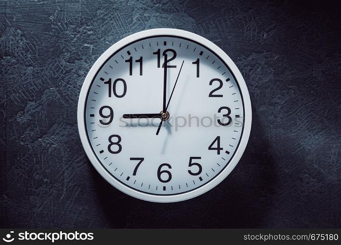 wall clock at old black background texture