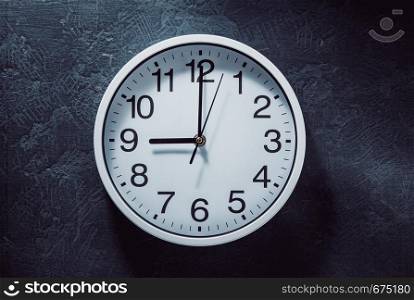 wall clock at old black background texture