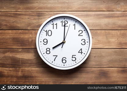 wall clock at wooden background texture