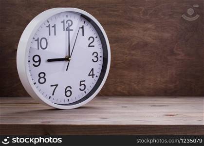 wall clock at wooden table background texture