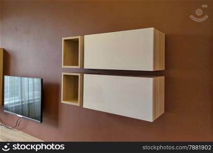 Wall in living room with cupboard and TV set