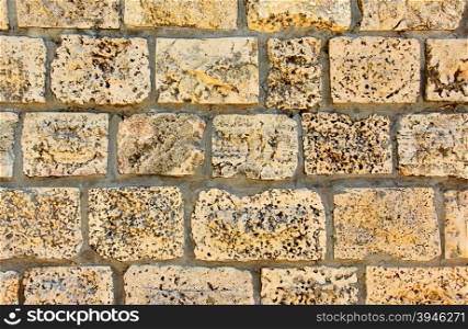 Wall made from sandstone bricks, may be used as background