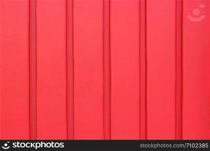 wall made of wooden planks or strips, red color. background, texture