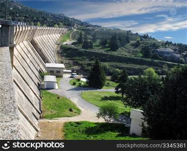 wall of a dam and a landscape with trees