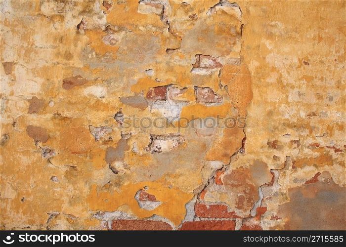 wall of a house partly in brick with yellow surface
