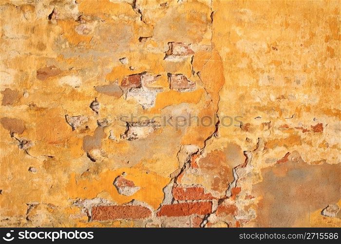 wall of a house partly in brick with yellow surface
