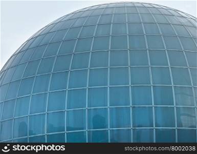 Wall of building in ball form with great number of windows. Architecture background.