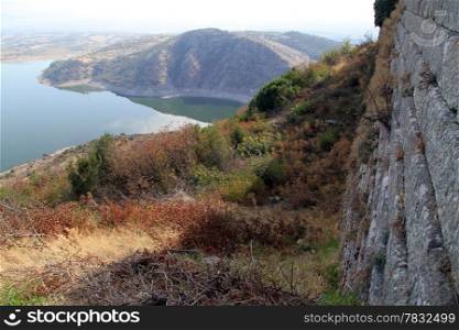 WAll of fortress in Acropolis in Pergam and lake, Turkey