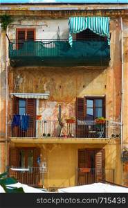 Wall of old building with balconies in Palermo, Sicily, Italy
