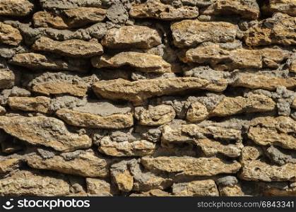 Wall of rough coquina stones. Shell stone textured wall.
