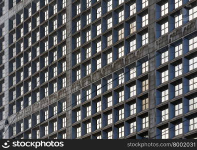 Wall of skyscraper with great number of windows. Architecture background.