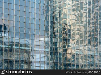 Wall of skyscraper with great number of windows. Architecture background.